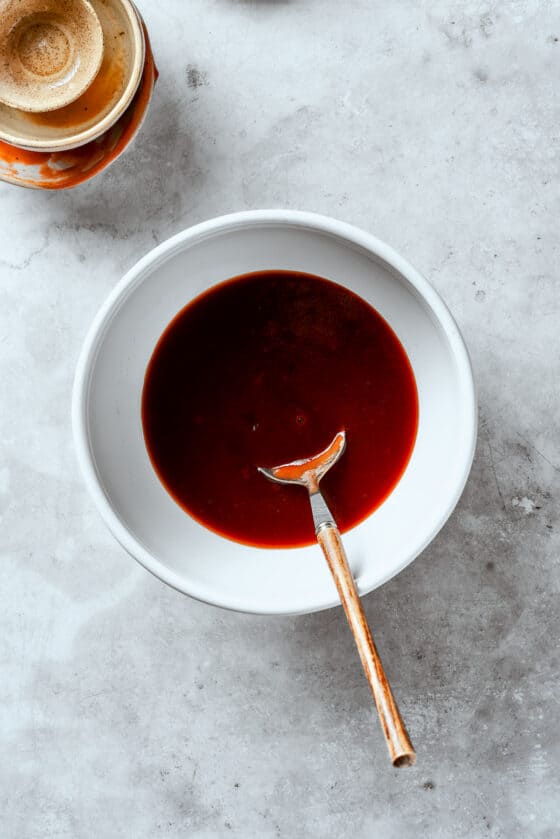 Tonkatsu sauce is stirred in a bowl.