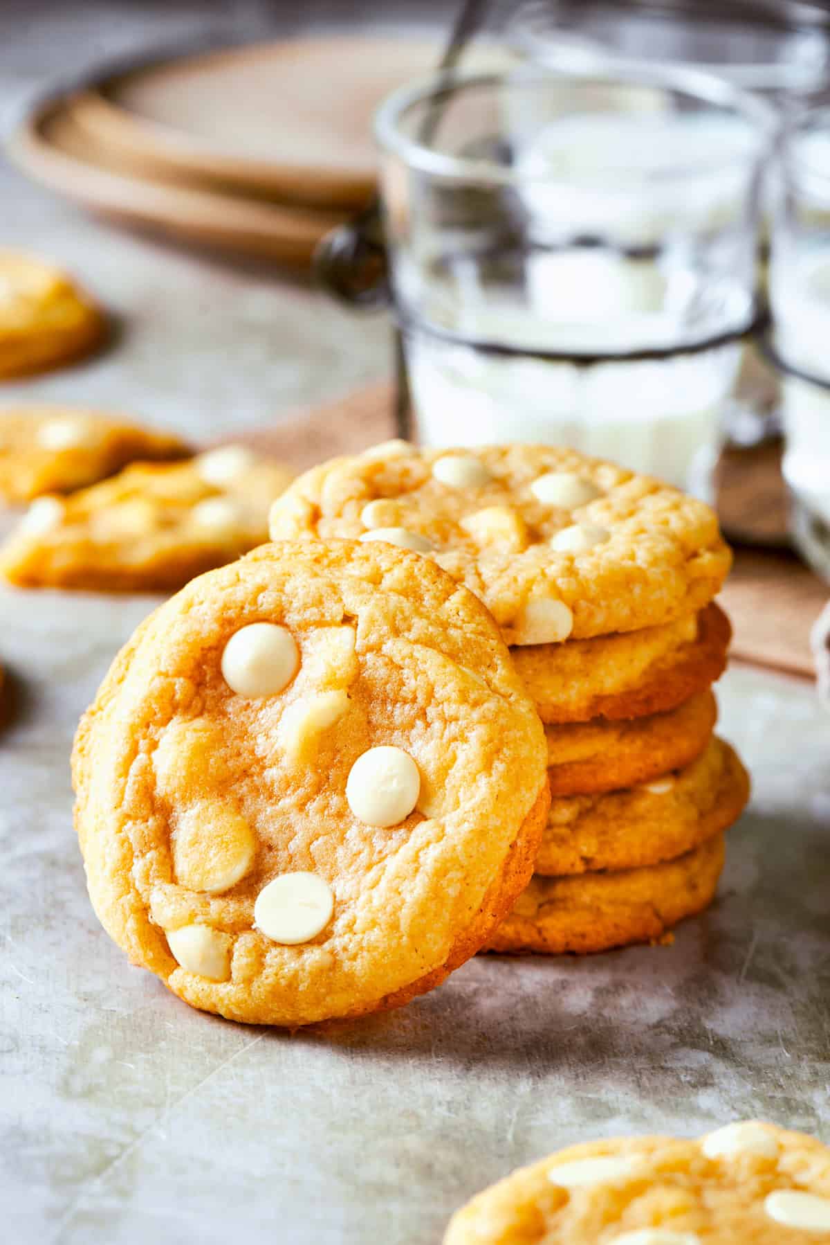 Stacked up white chocolate chip cookies.
