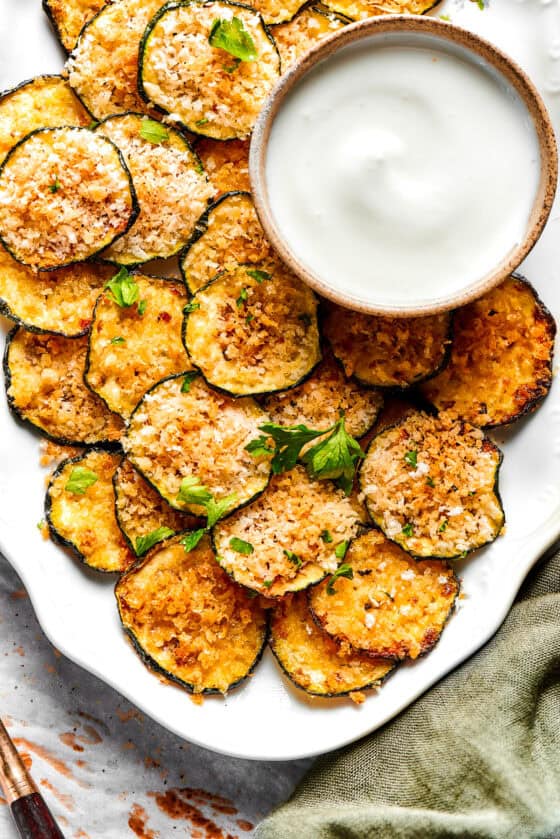 Zucchini chips served on a platter.