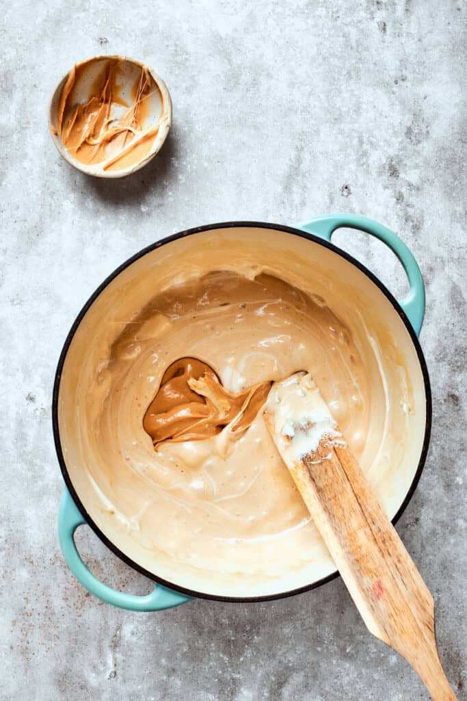 Peanut butter is stirred into the melted marshmallow mixture.