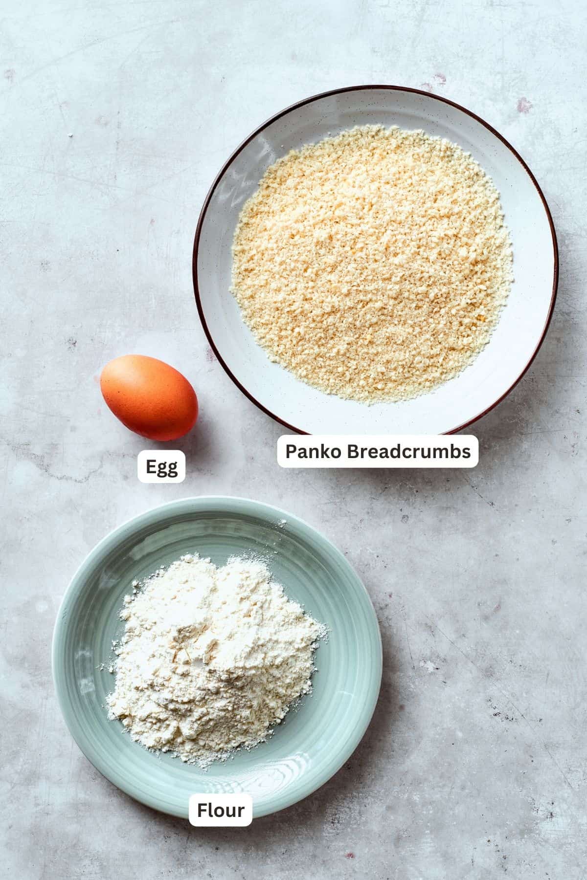 The breading to make shrimp burgers is shown portioned out an labelled: panko bread crumbs, flour, egg.