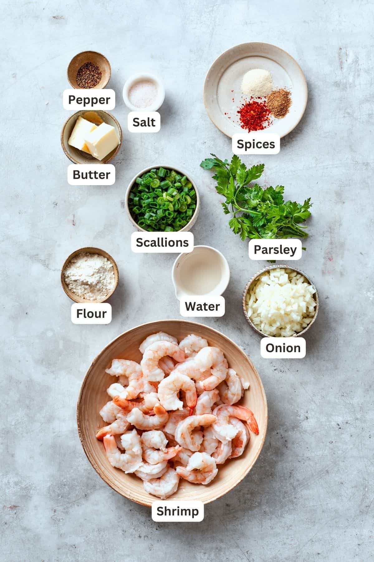 The ingredients for shrimp burgers are shown labelled: butter, pepper, salt, flour, spices, parsley, onion, water, scallions, shrimp.