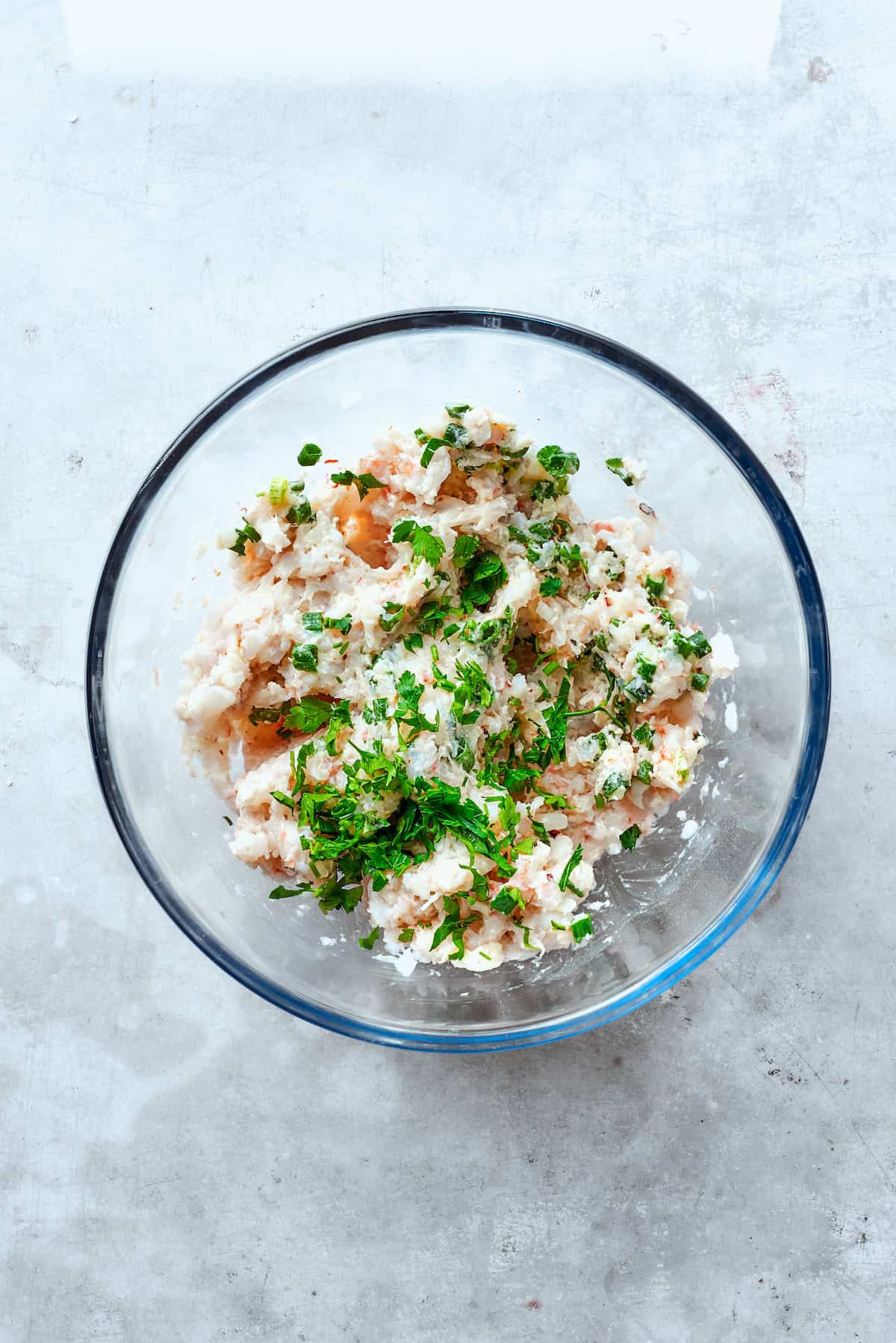 Parsley is added to the shrimp mixture.