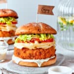 Sauce is seen dripping from a shrimp burger.