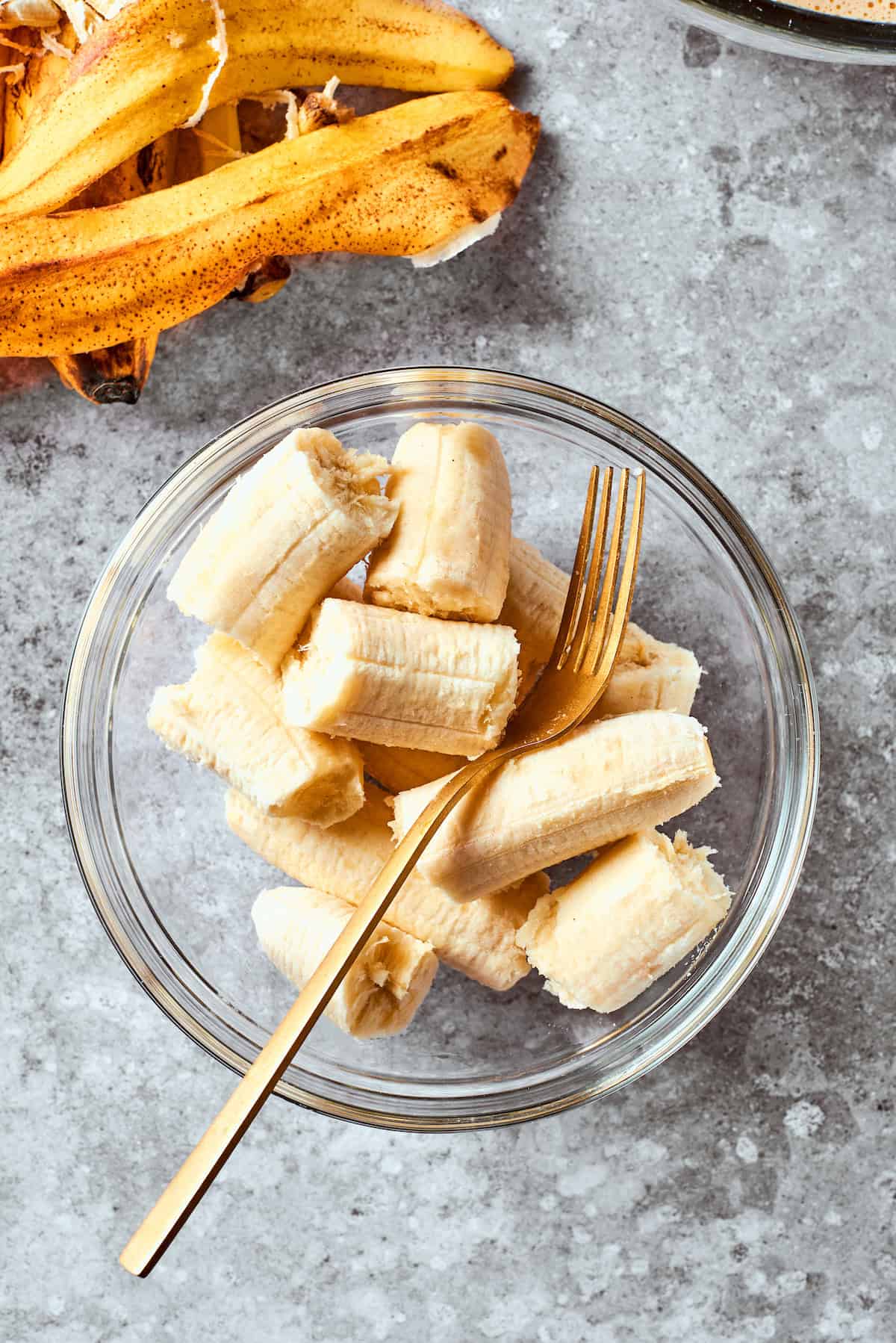 The bananas in a bowl with a fork.