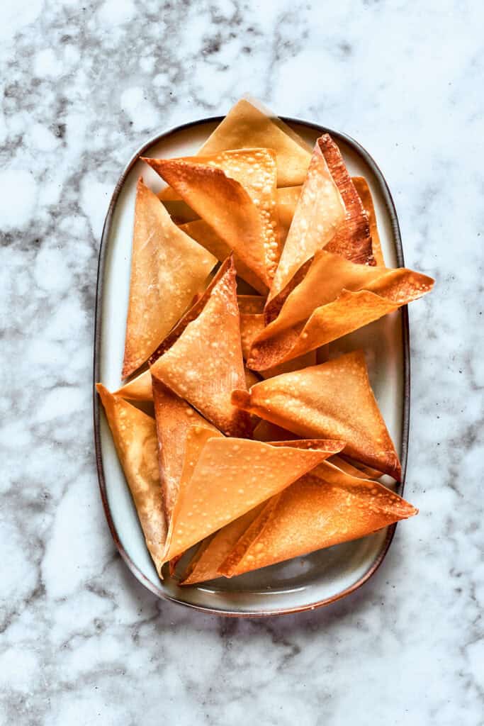 The crisp wonton wrappers on a dish.