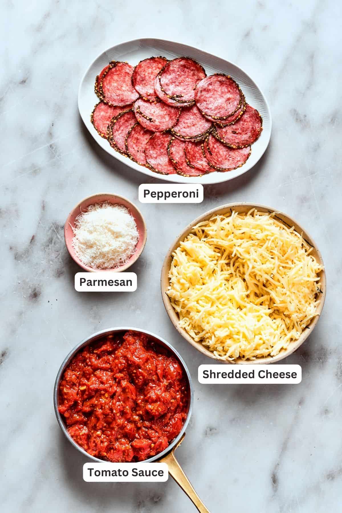 Deep dish pizza toppings: cheese, parmesan, tomato sauce, pepperoni.