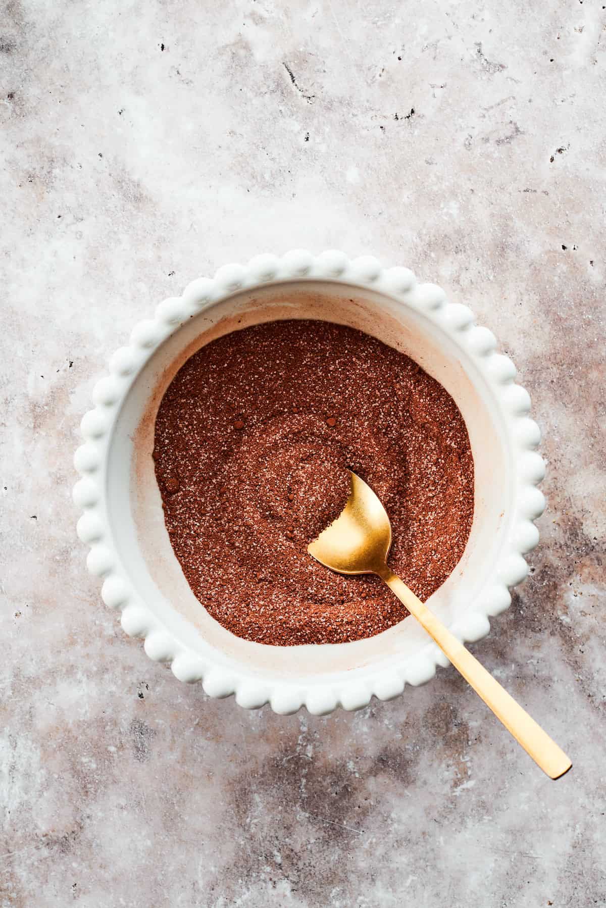 A spoon mixes the fudge topping.