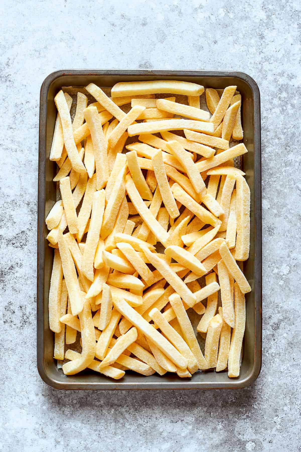 French fries are cooked on a baking sheet.