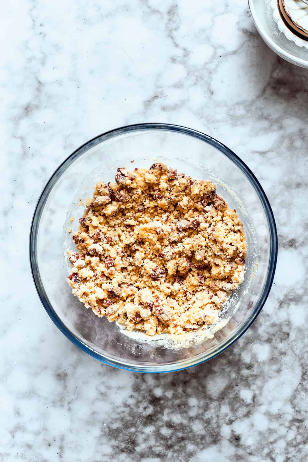 Crust ingredients are added to a glass bowl.