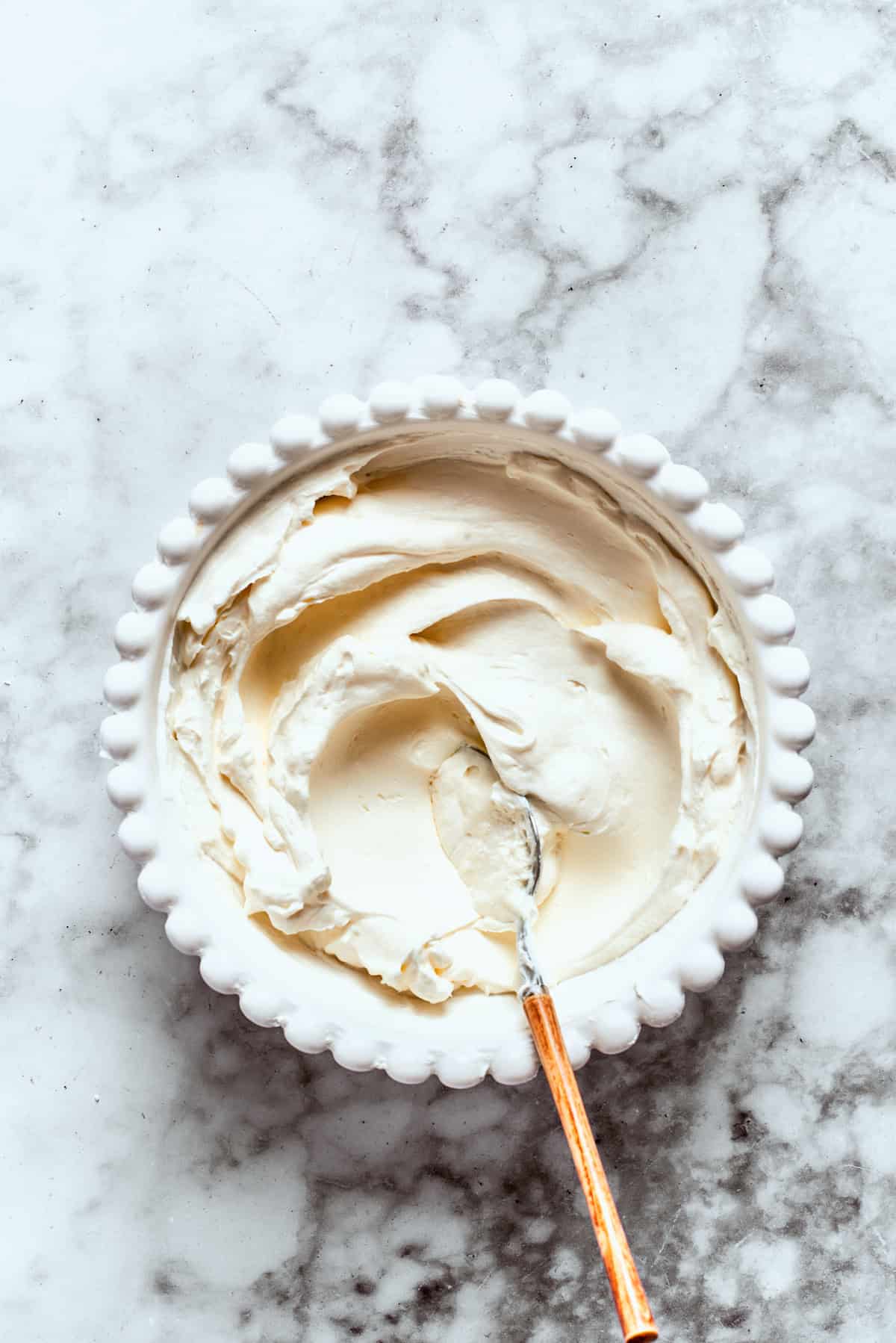 The cream cheese layer is mixed in a bowl.