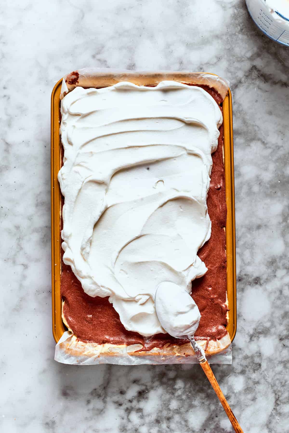 Cool Whip is spread over the top of the dessert.