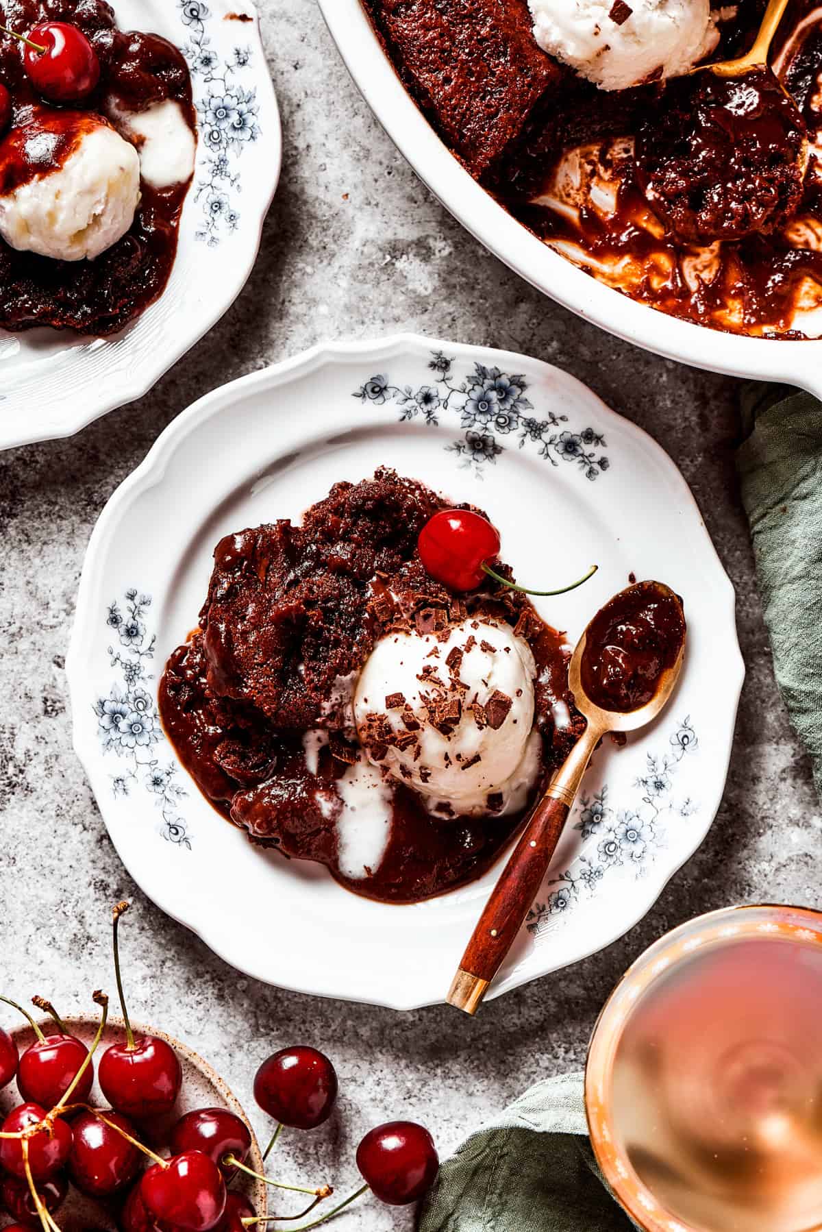 Pudding cake served on a dessert plate with a scoop of ice cream.