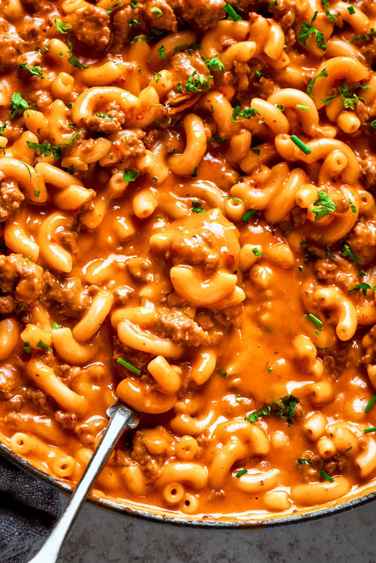 Close-up photo of homemade hamburger helper, a mix of elbow macaroni tossed in a ground beef sauce.