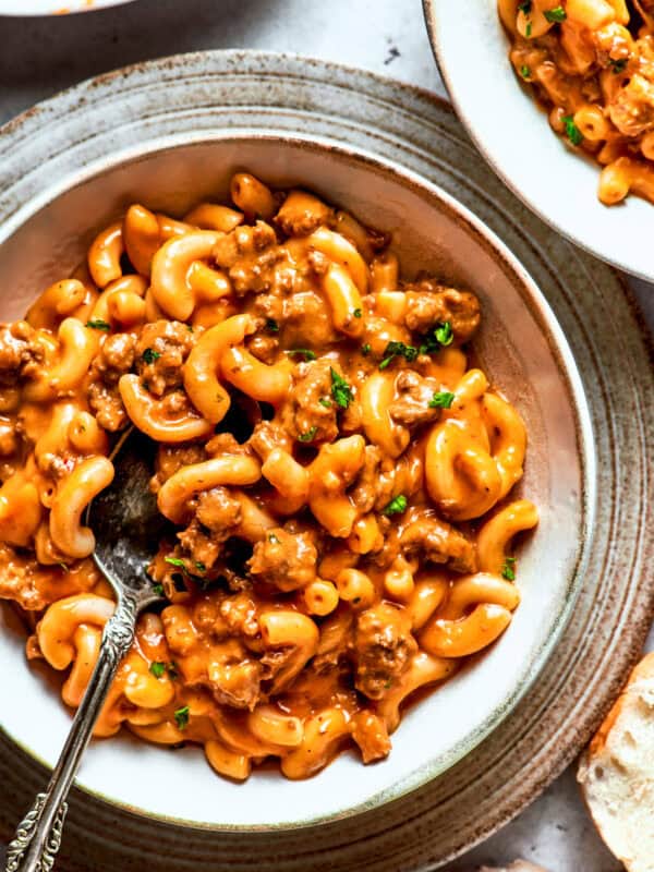 A bowl of macaroni tossed with beef sauce.