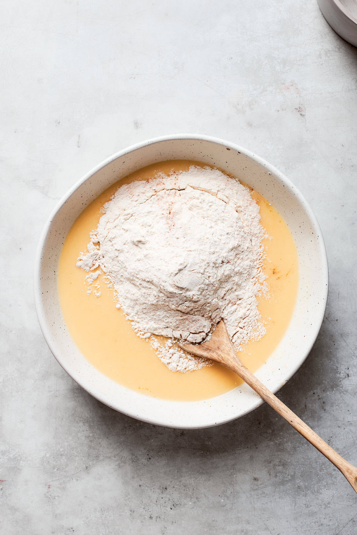 Flour is stirred into the batter.