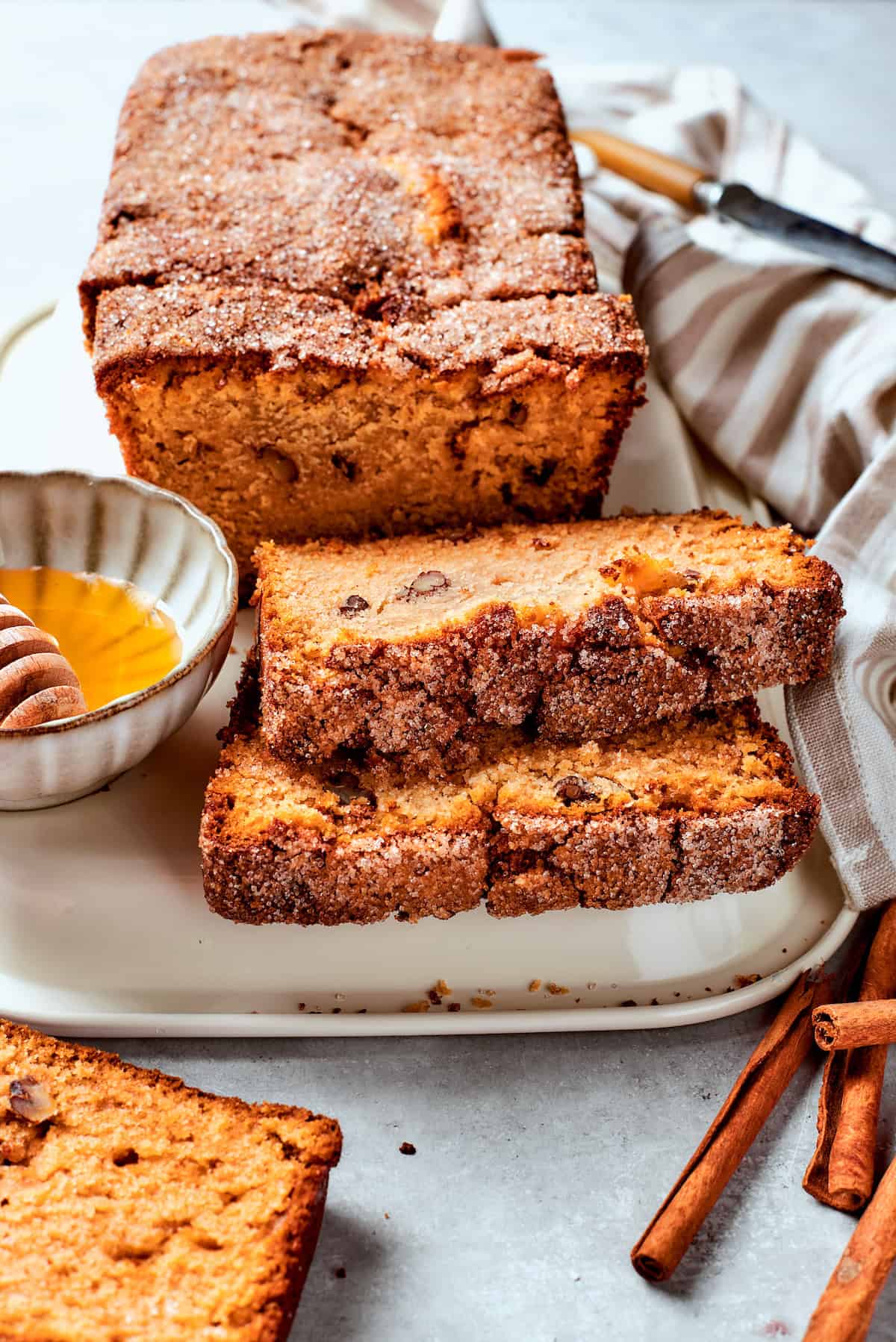 Slices of Amish friendship bread are buttered on a plate.