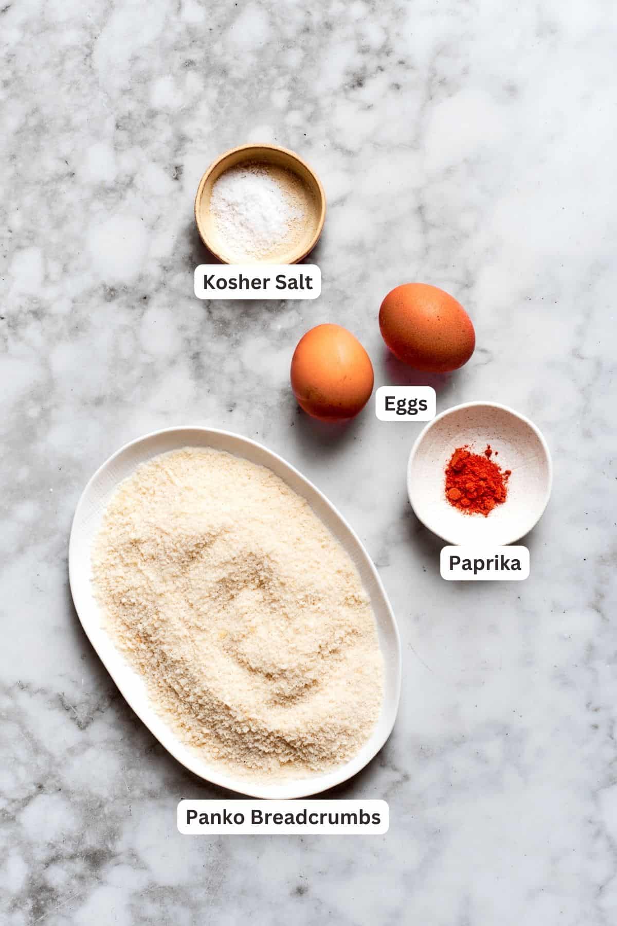 Breading ingredients for chicken nuggets recipe: panko breadcrumbs, salt, eggs, paprika.