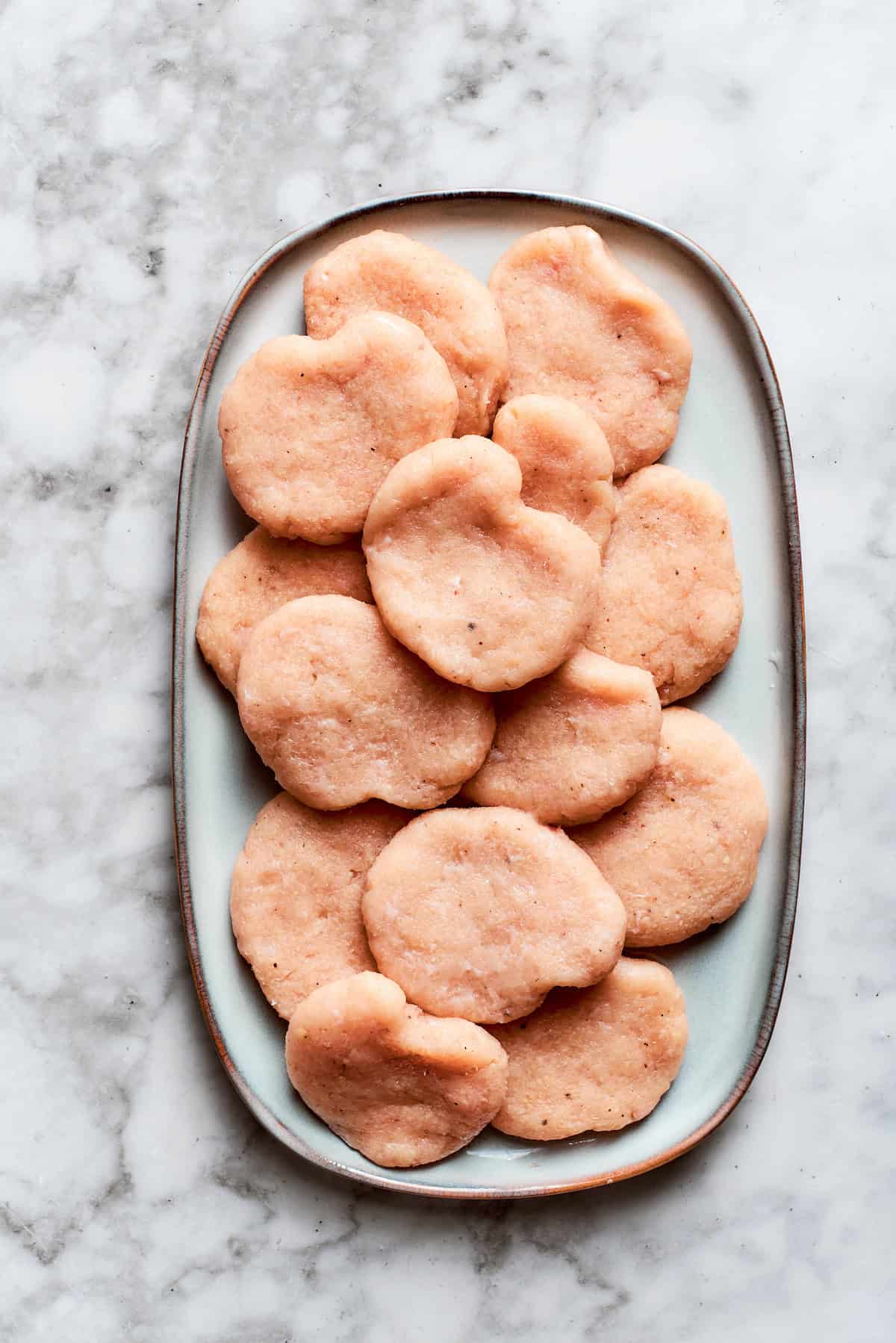 The nuggets are formed and placed on a plate.