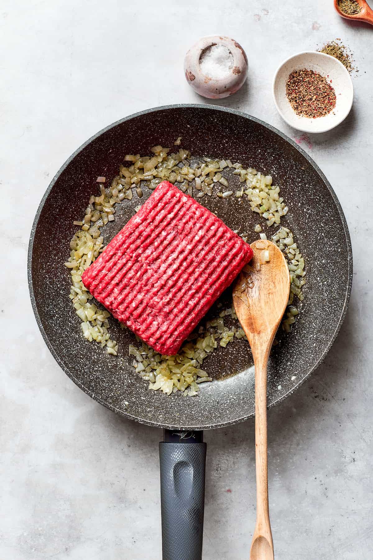 Ground beef is placed in a skillet.