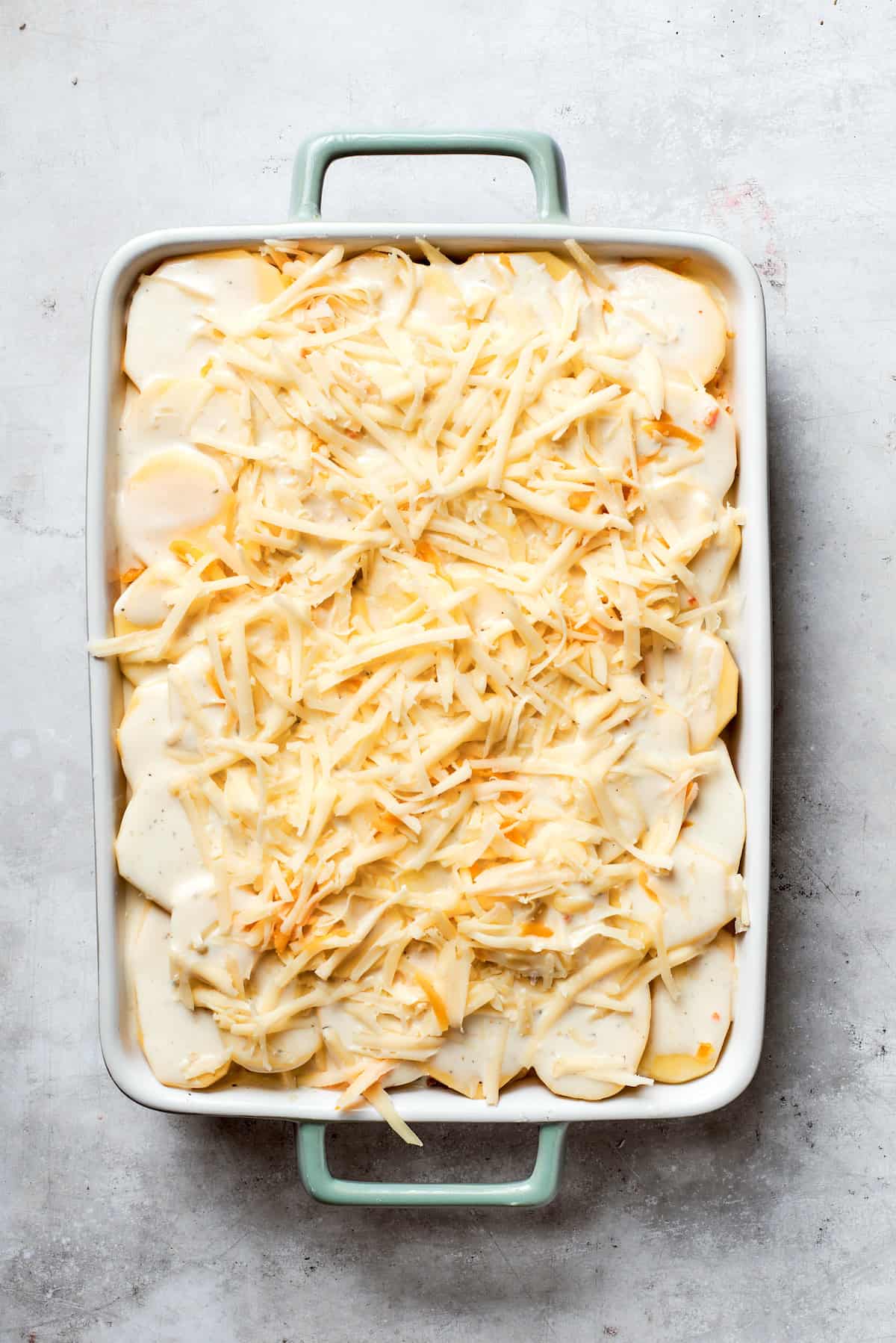 Cheese is added to the top of the casserole,