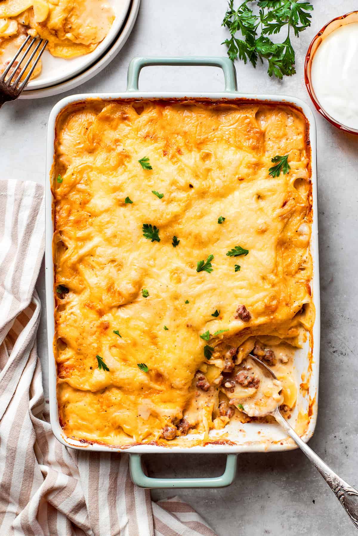 A big pan of hamburger potato casserole topped with cheese.