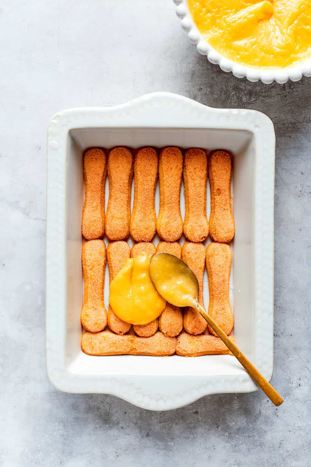 Lemon curd is spread on top of the cookies.