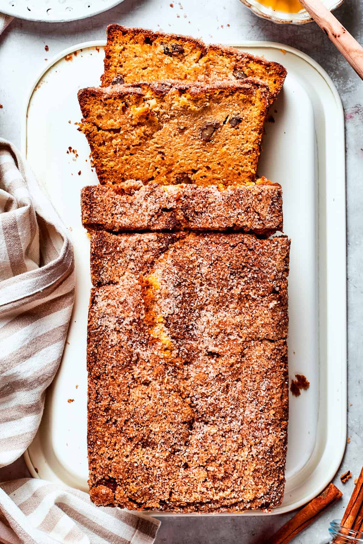 A loaf of Amish friendship bread is sliced on a cutting board.