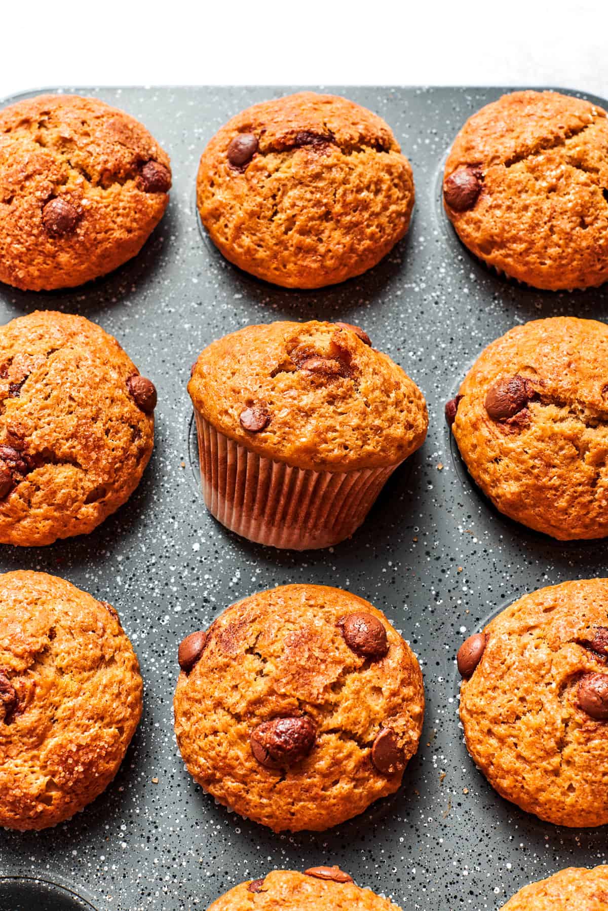 Nine banana muffins in a muffin tin.