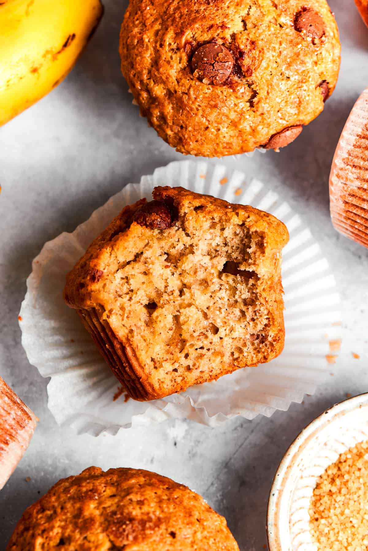 Halved muffin set flat on a cupcake liner, with the soft center exposed.