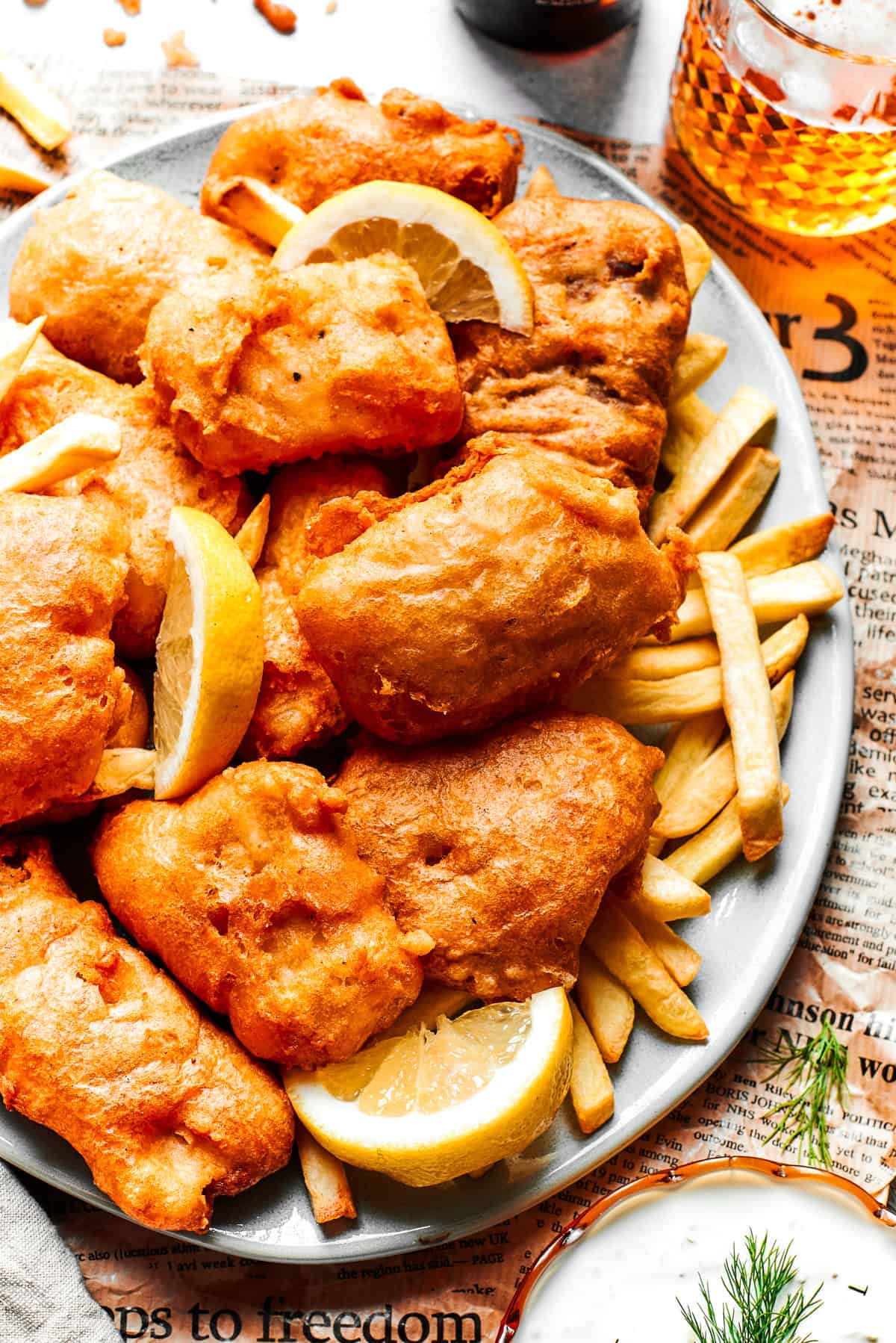 A platter with battered fish and chips.