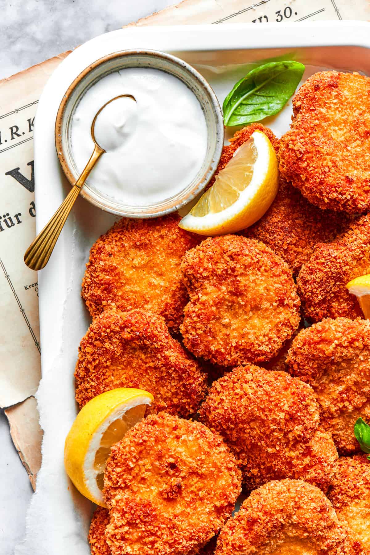 A pile of homemade chicken nuggets served with a side bowl of Ranch dressing.