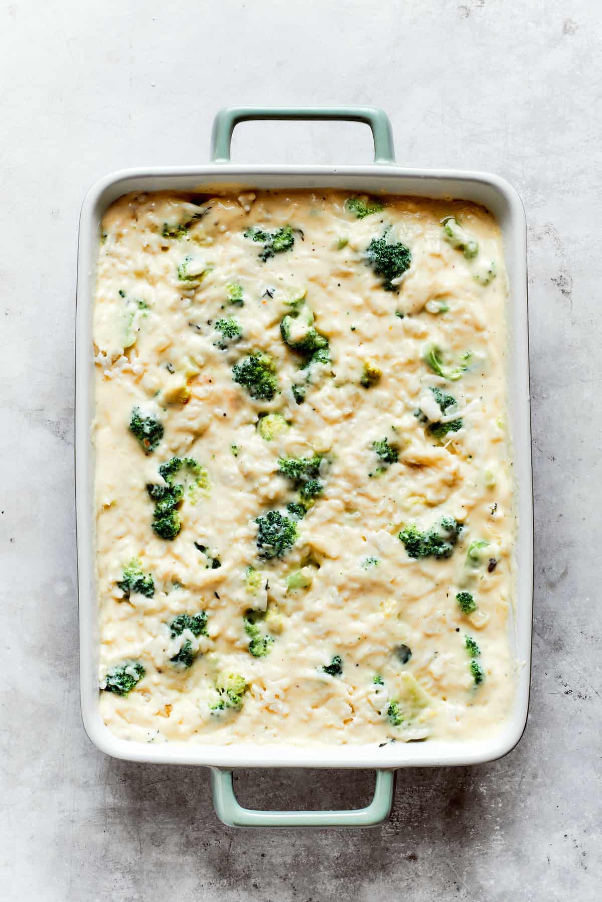 Broccoli and rice are mixed into cheese sauce in a pan for broccoli & rice casserole.