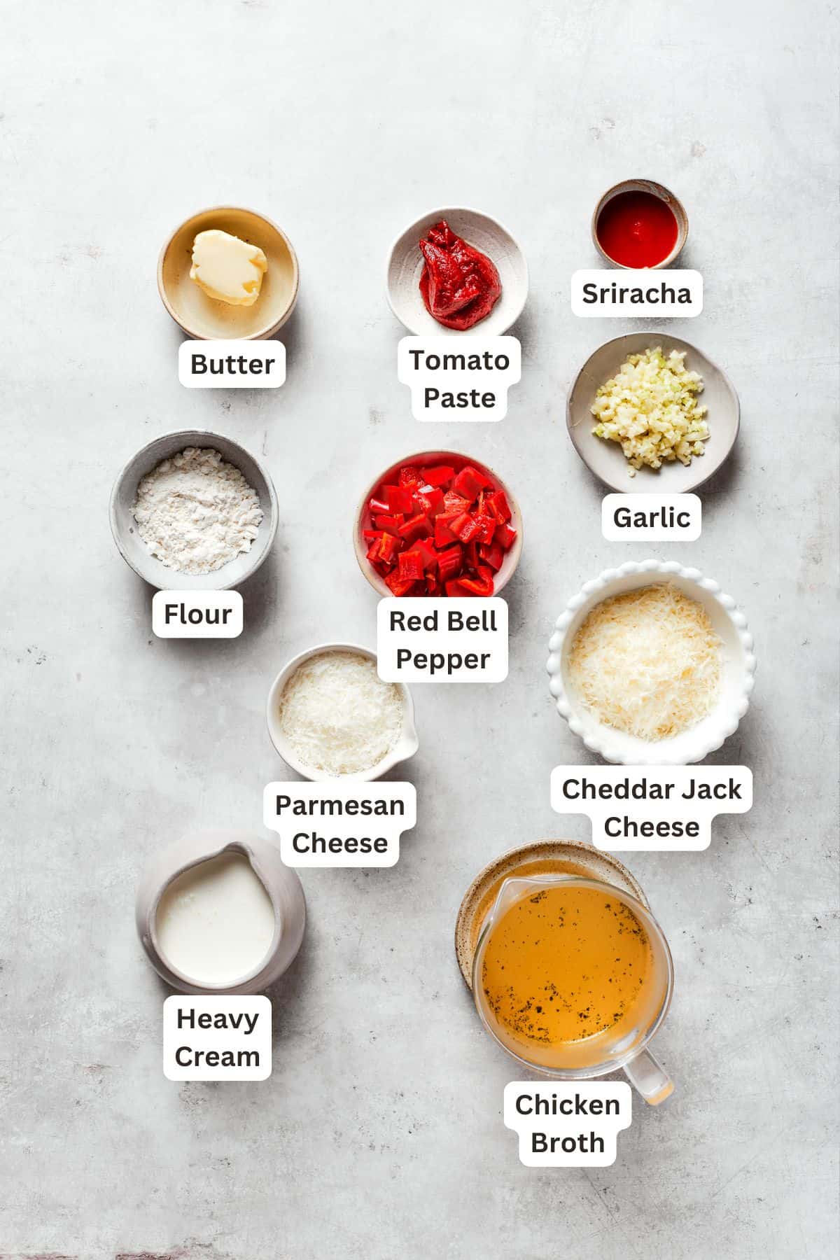 Labeled ingredients for cajun shrimp sauce include butter, tomato pasta, garlic, sriracha, cheddar jack cheese, parmesan cheese, heavy cream, chicken broth.