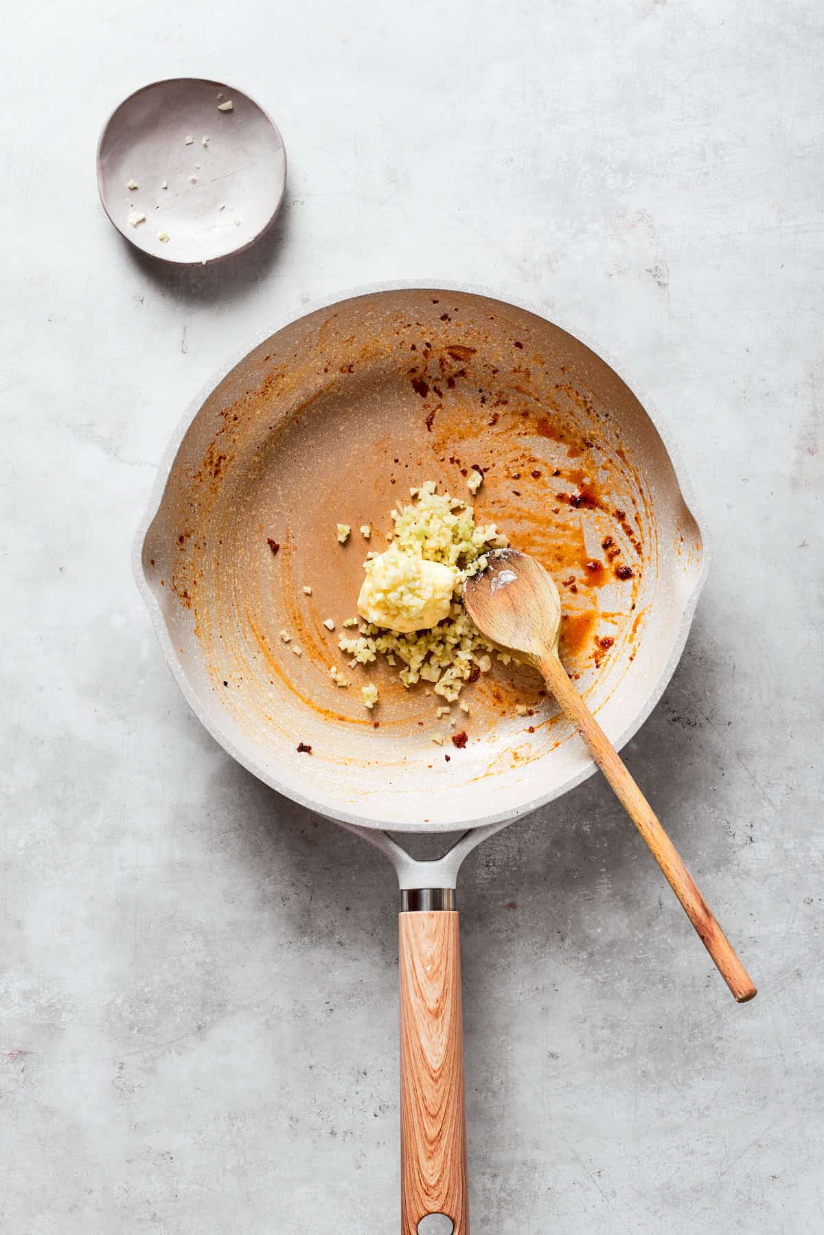 Butter is melted into a skillet with garlic.