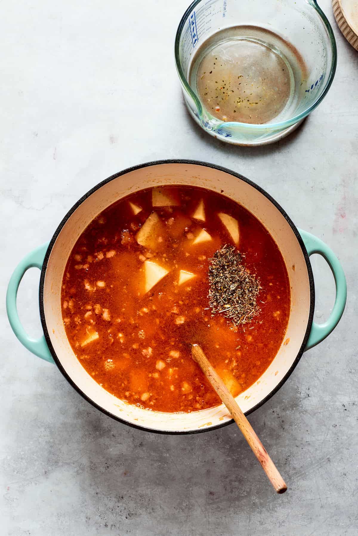 Broth is added in to the pot.