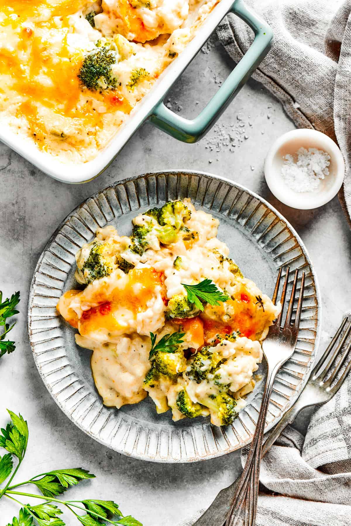 A serving of broccoli rice casserole served on a dinner plate.