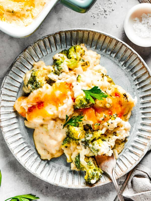 A serving of broccoli & rice casserole on a blue plate with a fork.