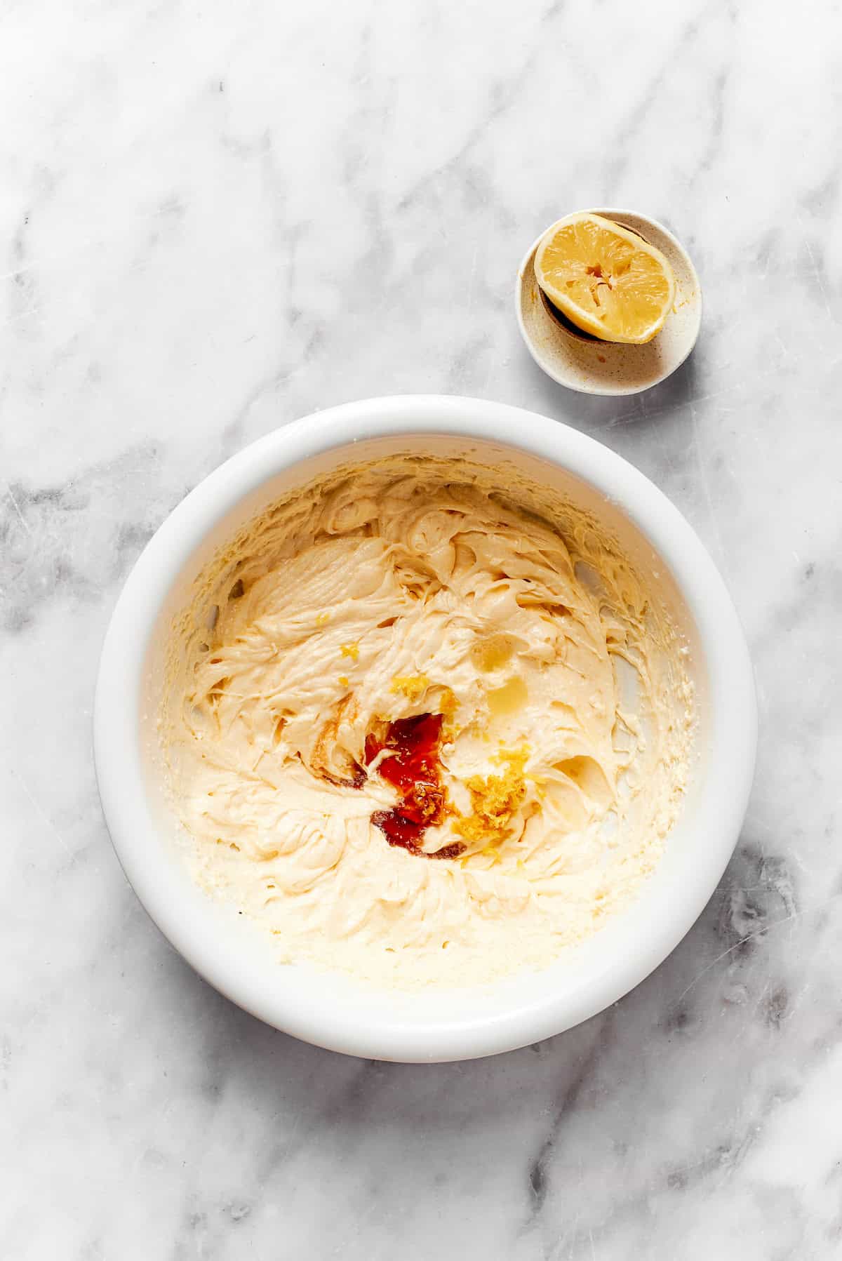 Vanilla is added to a bowl of dough.