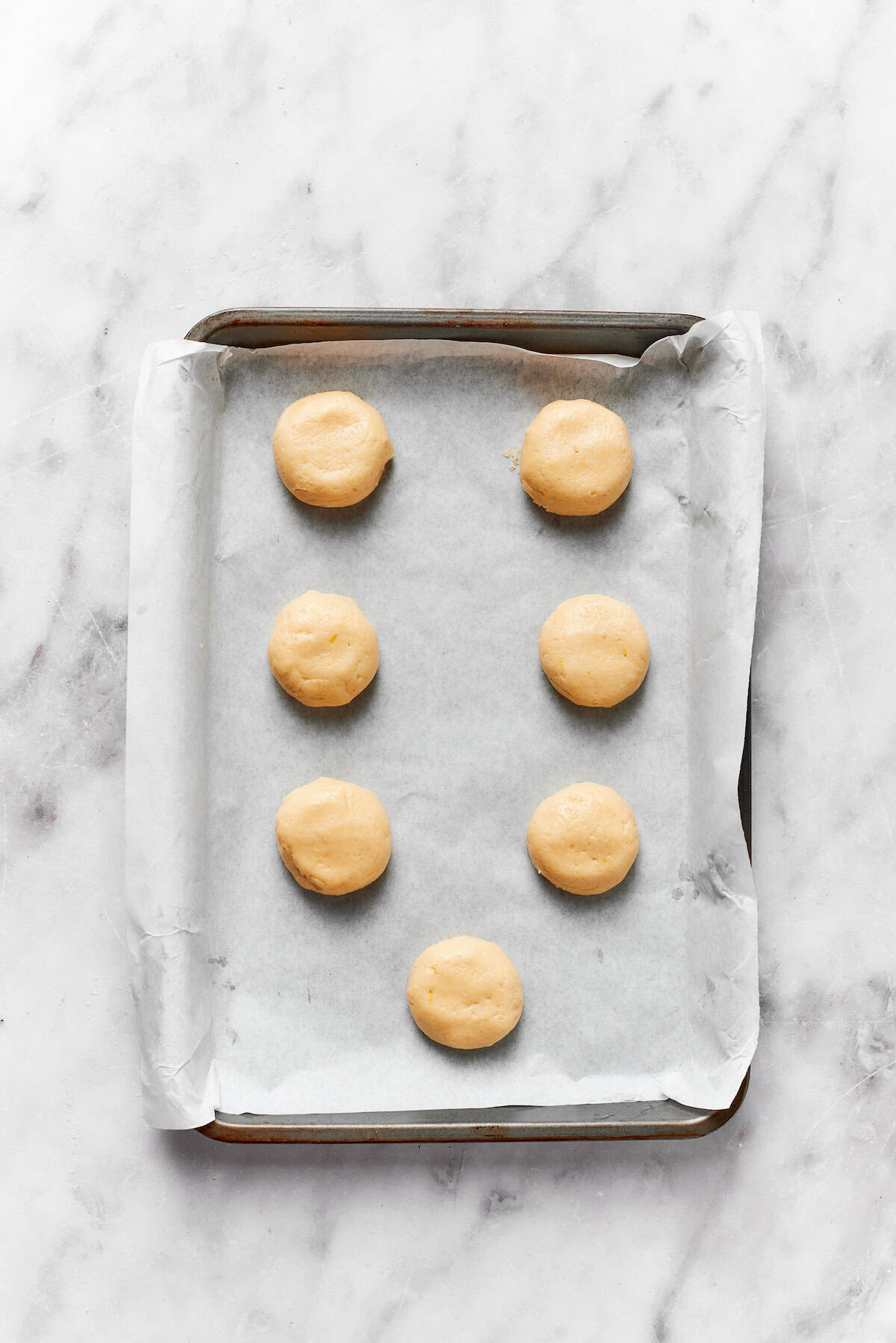 Anginetti cookie dough on a baking sheet.