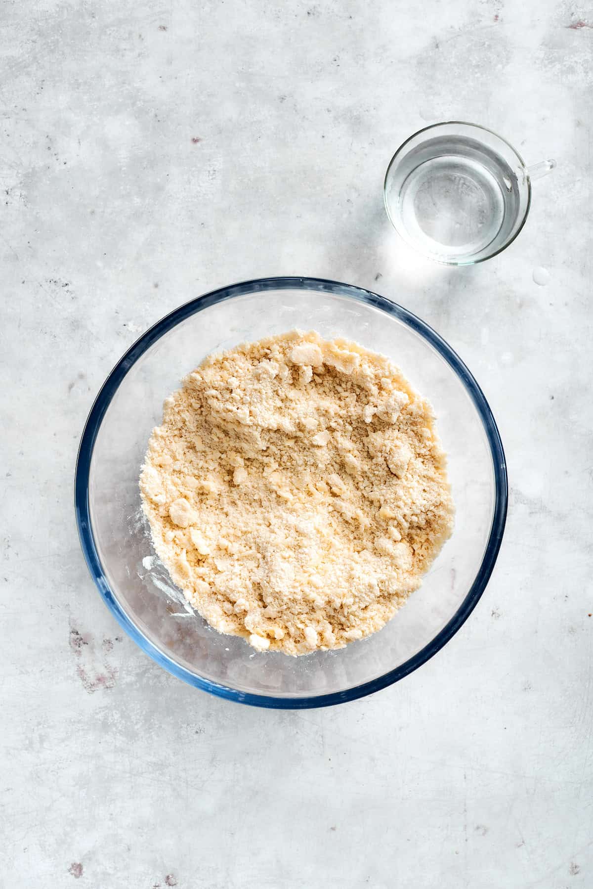 Mixing dough ingredients in a glass bowl.