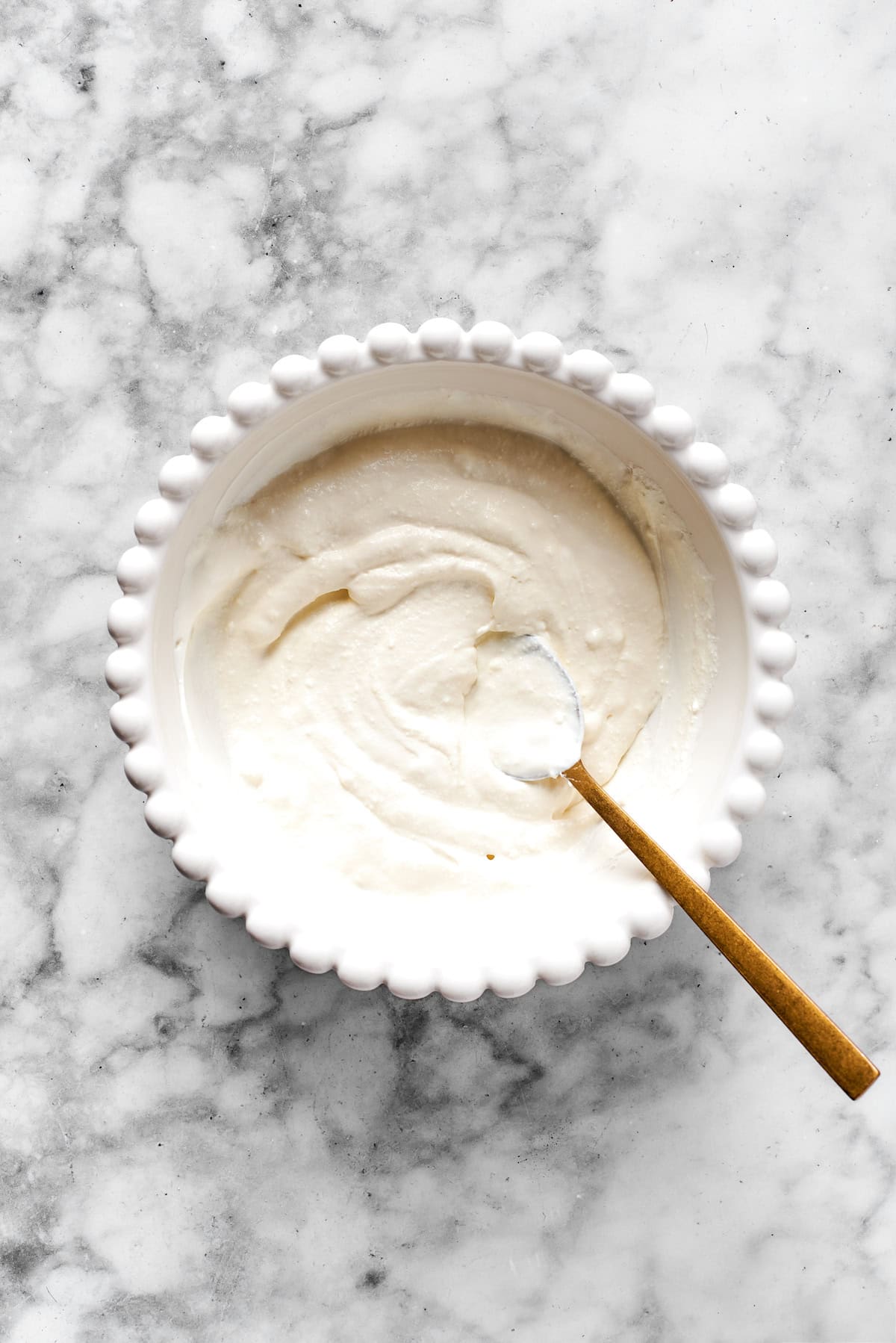 Finished cheese mixture in a white bowl.