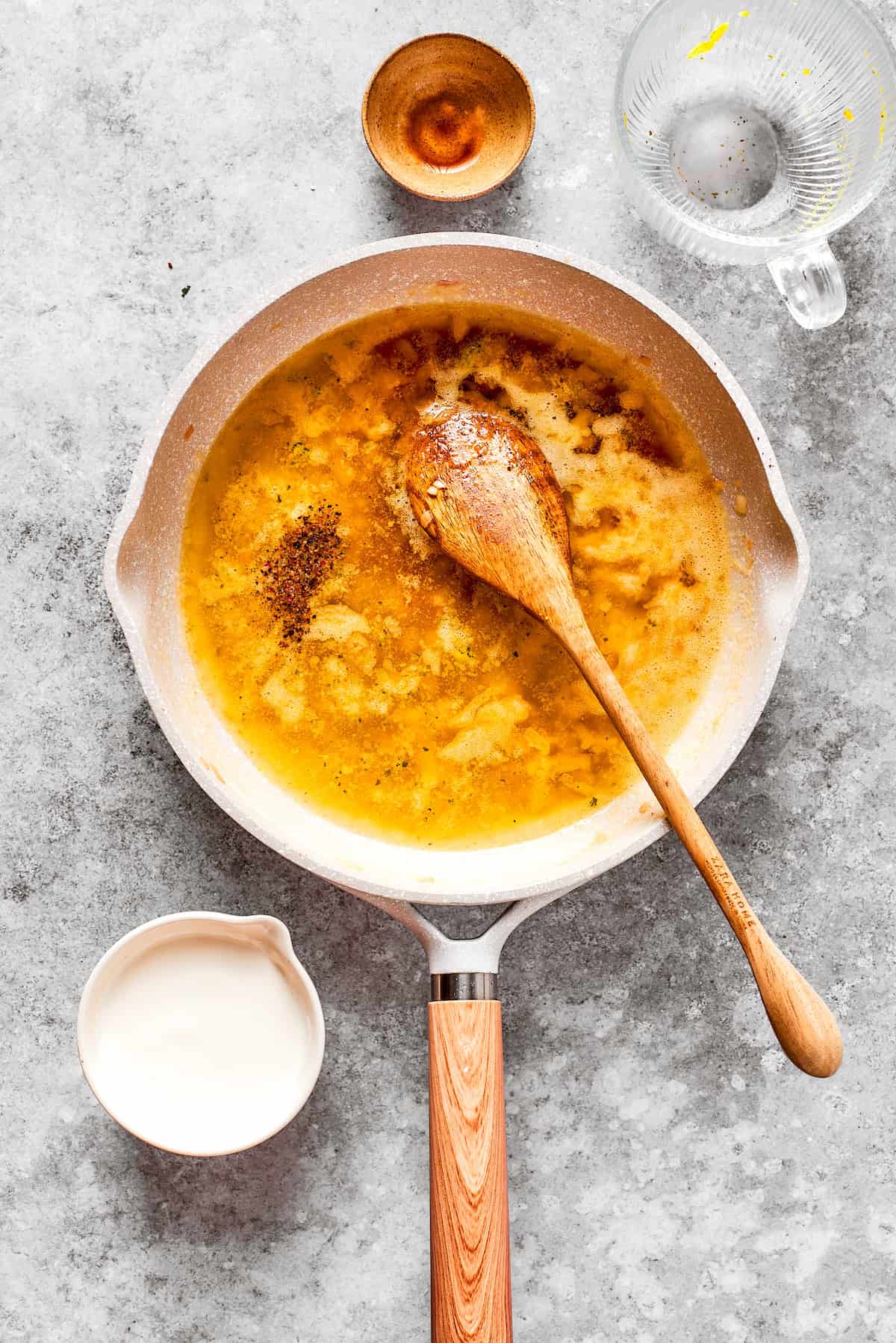 Flour is cooked into roux in a pan.