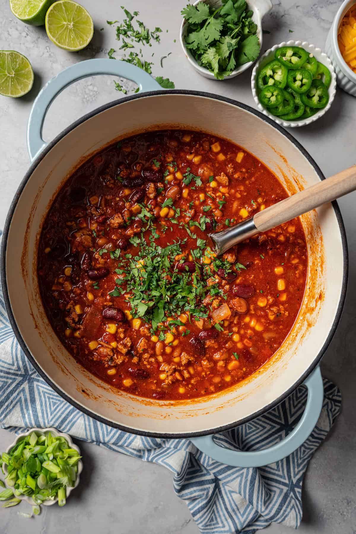 Finished turkey chili garnished with cilantro in a large pot.