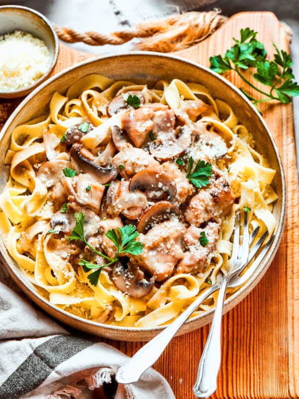 Chicken fettuccine on a cutting board.