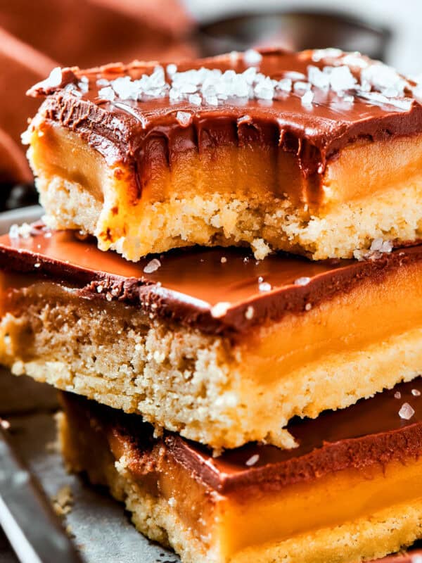 A stack of millionaire bars with a bite taken out of the top bar.