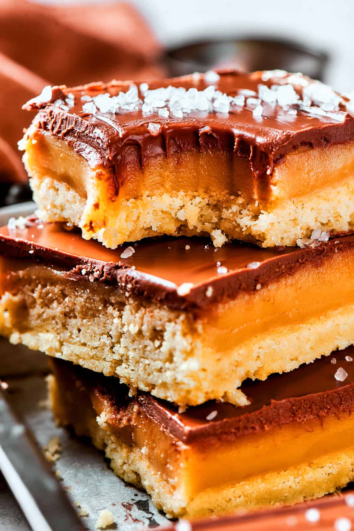 A stack of millionaire bars with a bite taken out of the top bar.