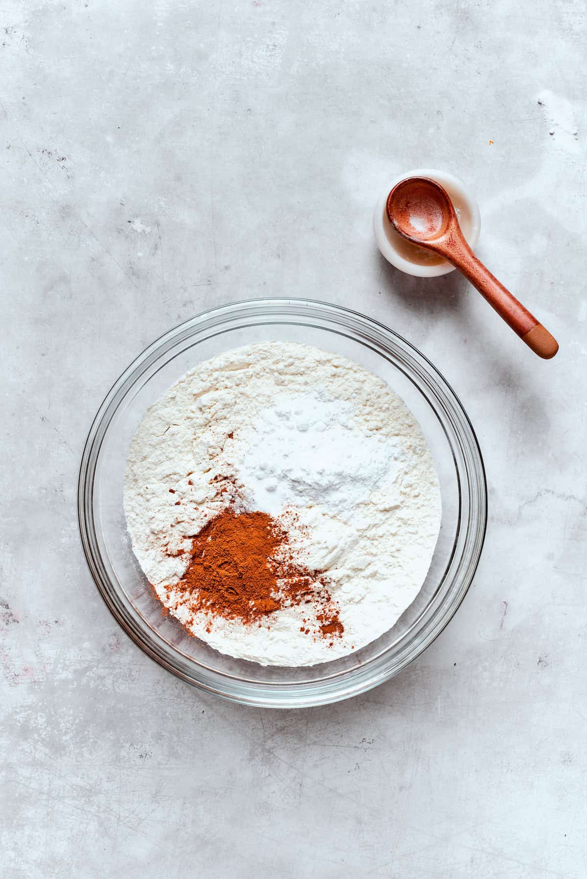 Dry ingredients are combined in a bowl for apple cider donuts.