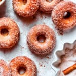 Cinnamon sugar is added to apple cider donuts.