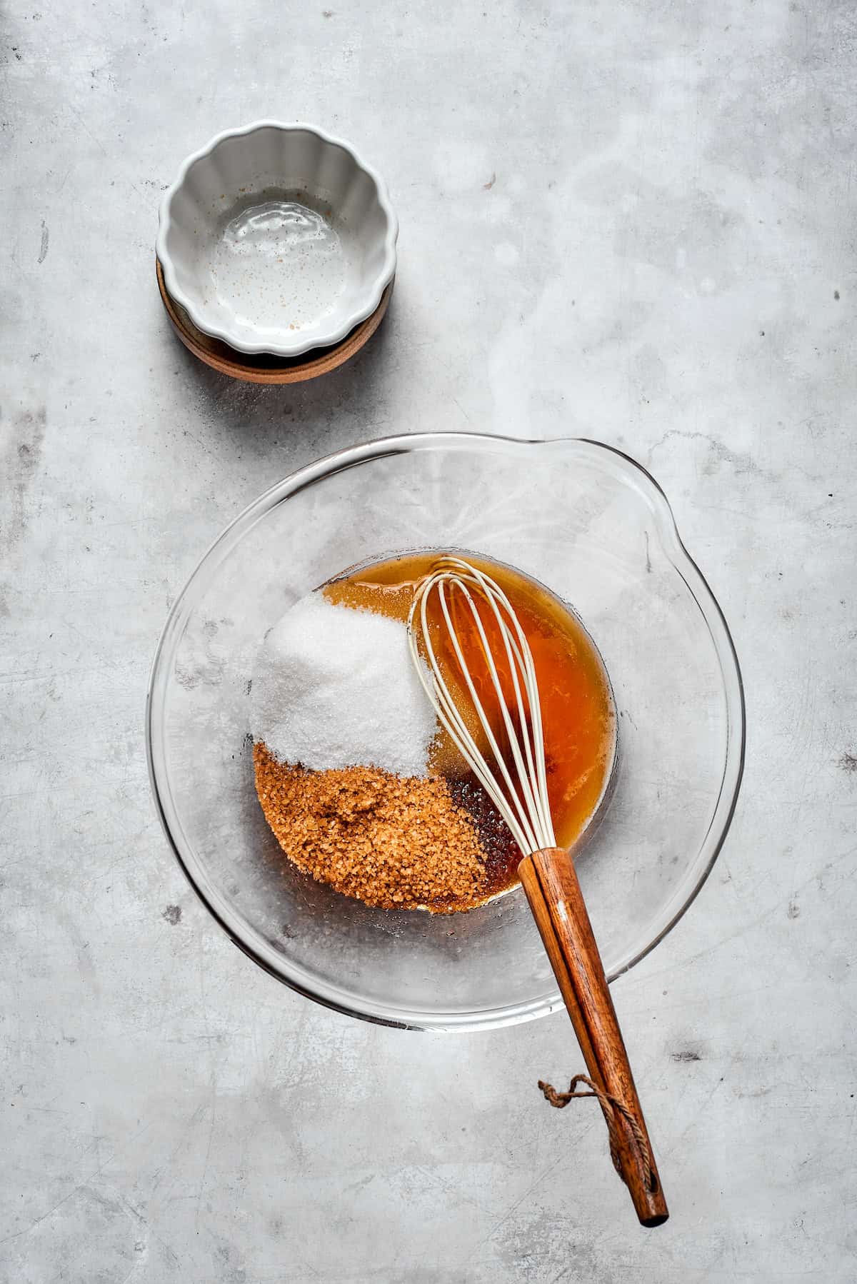 White and brown sugars are whisked into a bowl of browned butter.